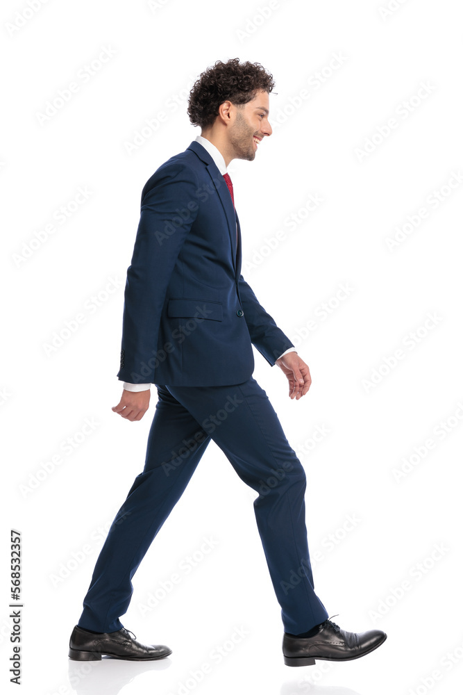 side view of curly hair man being happy, smiling and walking side view of curly hair man being happy, smiling and walking