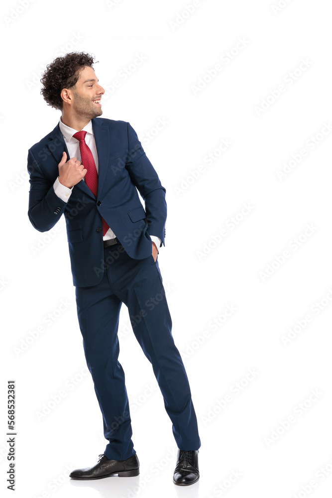 attractive arabic man with hand in pocket looking to side and walking attractive arabic man with hand in pocket looking to side and walking