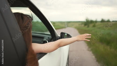Wallpaper Mural Happy girl in car window. Hair in wind. Girl travels by car. Hand in sun. Windy breeze from car window. Happy girl smiling from car window. Windy breeze in your hair. Hand in the rays of the sun Torontodigital.ca