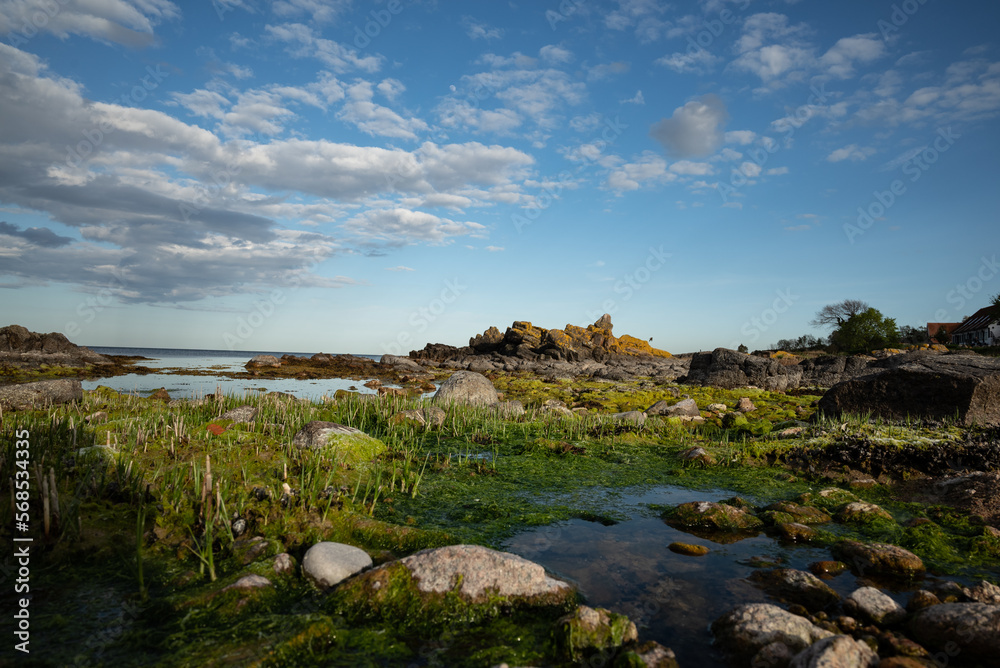Colorful shot of a rocky stone formation and little sea ponds on the baltic sea in Allinge on Bornholm