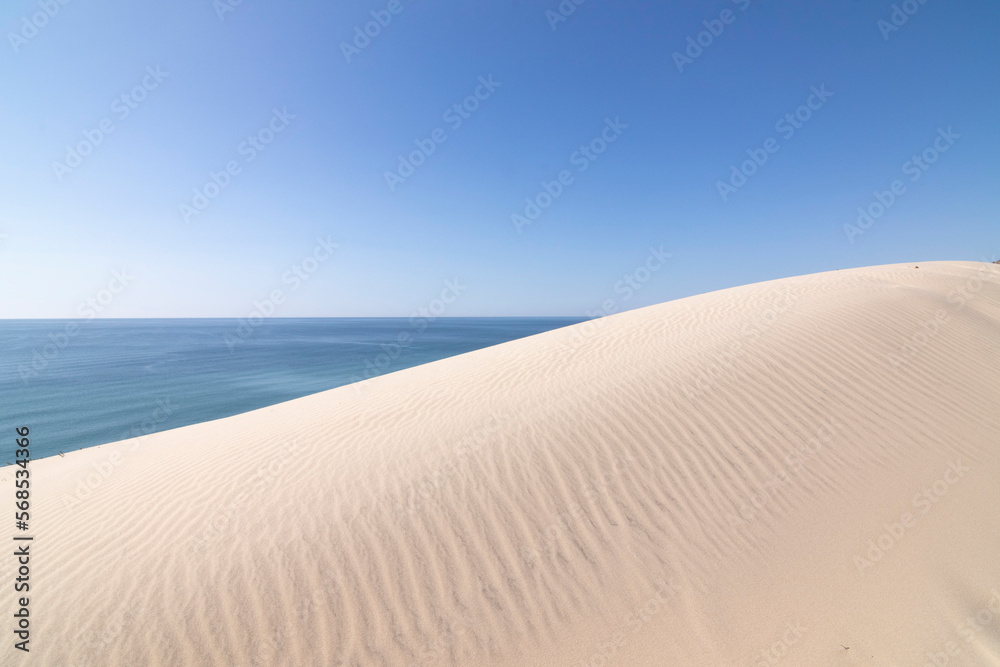 The sky, the sea and the sand dunes as a background. The beach El Asperillo, Huelva, Spain. Background for magazines.