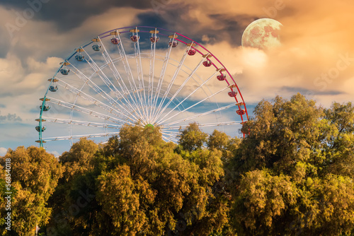 Ferris wheel on the background of the Moon and a beautiful sunset. Ayia Napa. Cyprus. photo