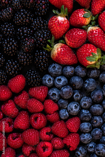 Fresh summer wild berries : strawberry,blackberry,raspberries,blueberry. Full frame. Close up photo. Top view.