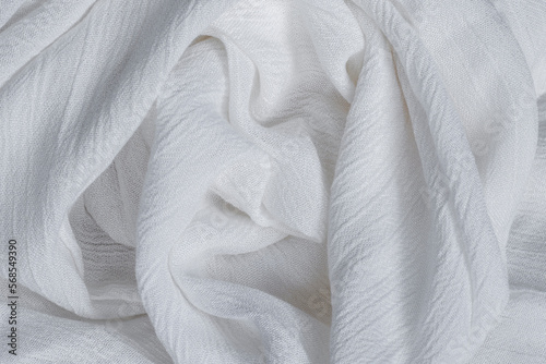 Wrinkled white viscose fabric. Artificial fiber from natural wood pulp. Textile texture as background