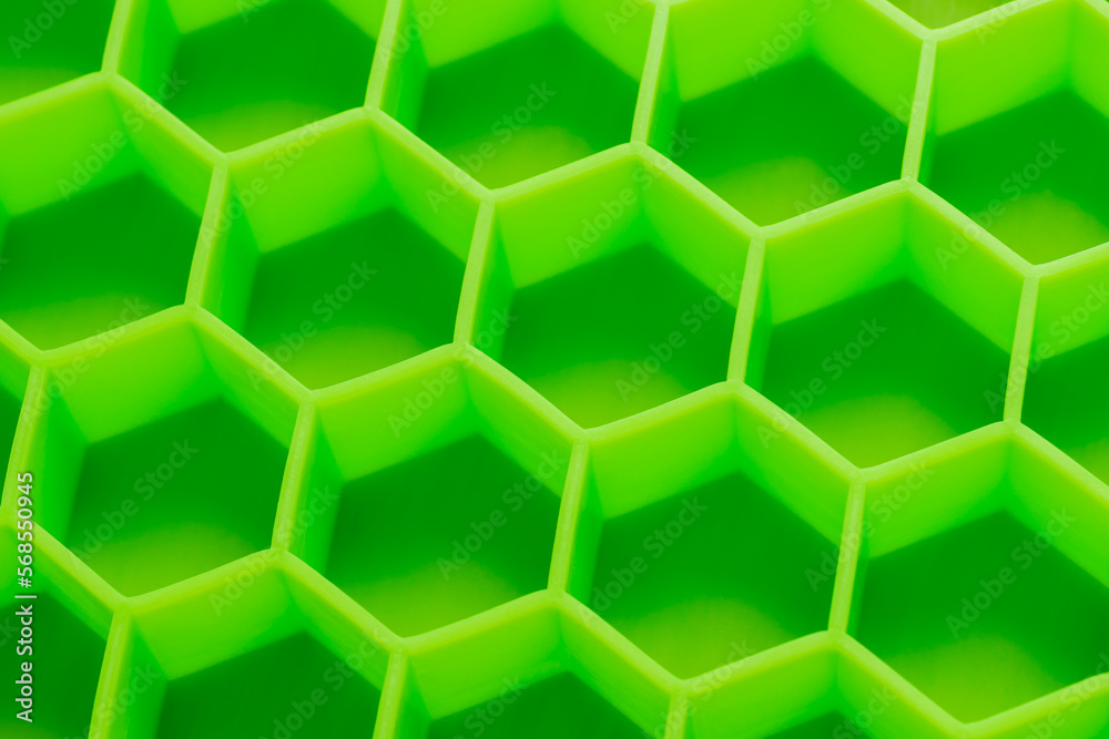 Fototapeta premium Hexagonal shapes ice maker. Textured silicone ice cube tray. Hexagonal pattern mold