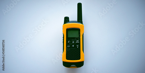 Portable radio station in yellow on a white background.Orange tourist walkie-talkie.