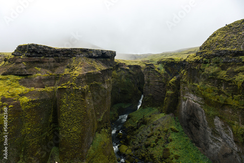 Beautiful landscape with land covered in green moss in Iceland on a cloudy day