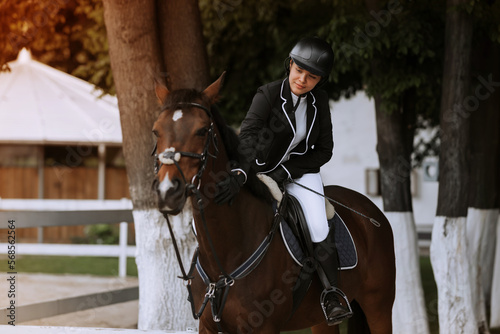 The sportswoman on a horse. . Equestrianism. Horse riding. Horse racing. Rider on a horse. © JJ Studio