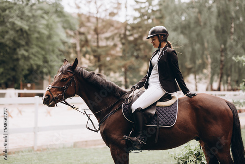The sportswoman on a horse. The horsewoman on a red horse. Equestrianism. Horse riding. Horse racing.