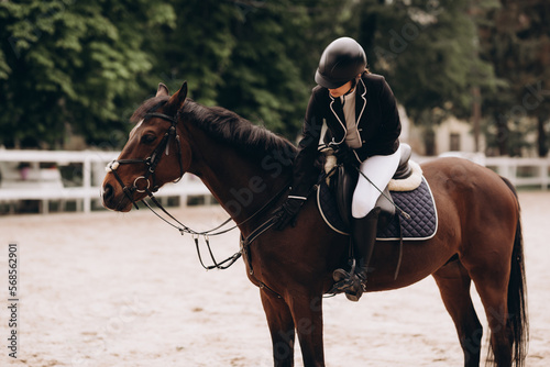 Caring equestrian. Caring professional equestrian calming his favorite horse before important horserace © JJ Studio