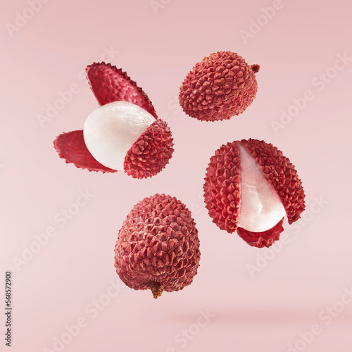Fresh ripe red lychee falling in the air isolated