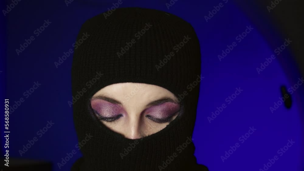 Portrait of a beautiful young Muslim woman in a hijab and with facial makeup with a mirror on a uniform background. Use for fashion and beauty concept. Portrait of a beautiful young Muslim woman in a hijab and with facial makeup with a mirror on a uniform background. Use for fashion and beauty concept.