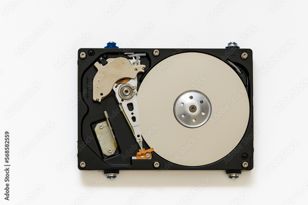 Disassembled hard drive on a white background, isolated. The electronic insides of the information storage device, the reading head. Disassembled hard drive on a white background, isolated. The electronic insides of the information storage device, the reading head.