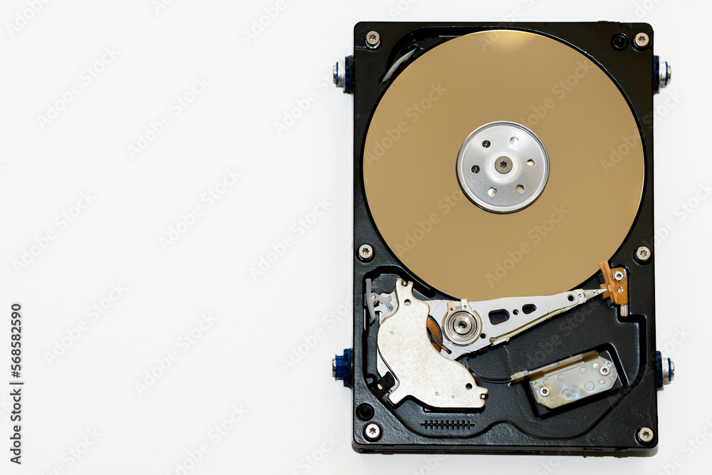 Disassembled hard drive on a white background, isolated. The electronic insides of the information storage device, the reading head. Disassembled hard drive on a white background, isolated. The electronic insides of the information storage device, the reading head.