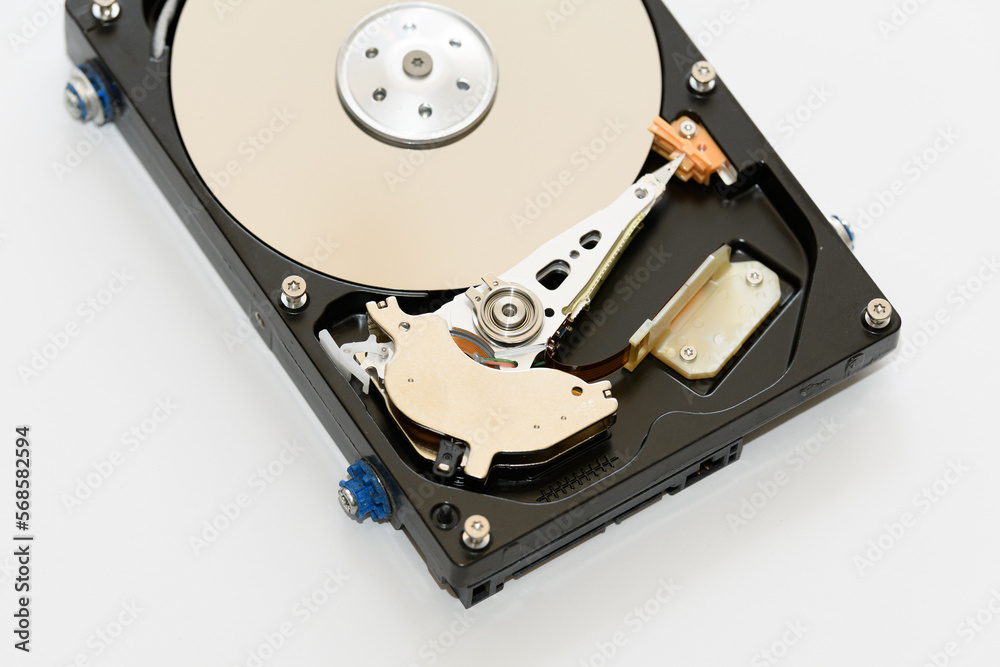 Disassembled hard drive on a white background, isolated. The electronic insides of the information storage device, the reading head. Disassembled hard drive on a white background, isolated. The electronic insides of the information storage device, the reading head.