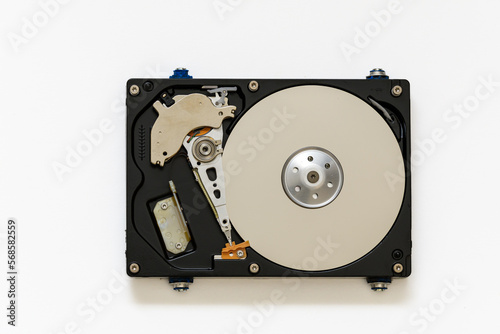 Disassembled hard drive on a white background, isolated. The electronic insides of the information storage device, the reading head.