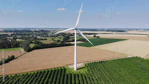 Scenic aerial drone view of wind trubines and green and yellow fields in Normandy, France photo