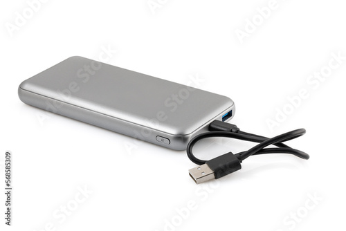Additional autonomous power bank for charging mobile devices. External battery isolated on white background. Silver charger for a smartphone with a power supply  battery . Full depth of field.