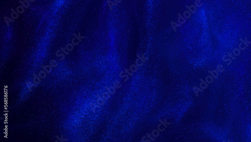 Various stains and overflows of particles in blue fluid with silver tints. Golden particles dust and smooth defocused background. Liquid iridescent shiny backdrop with depth of field.
