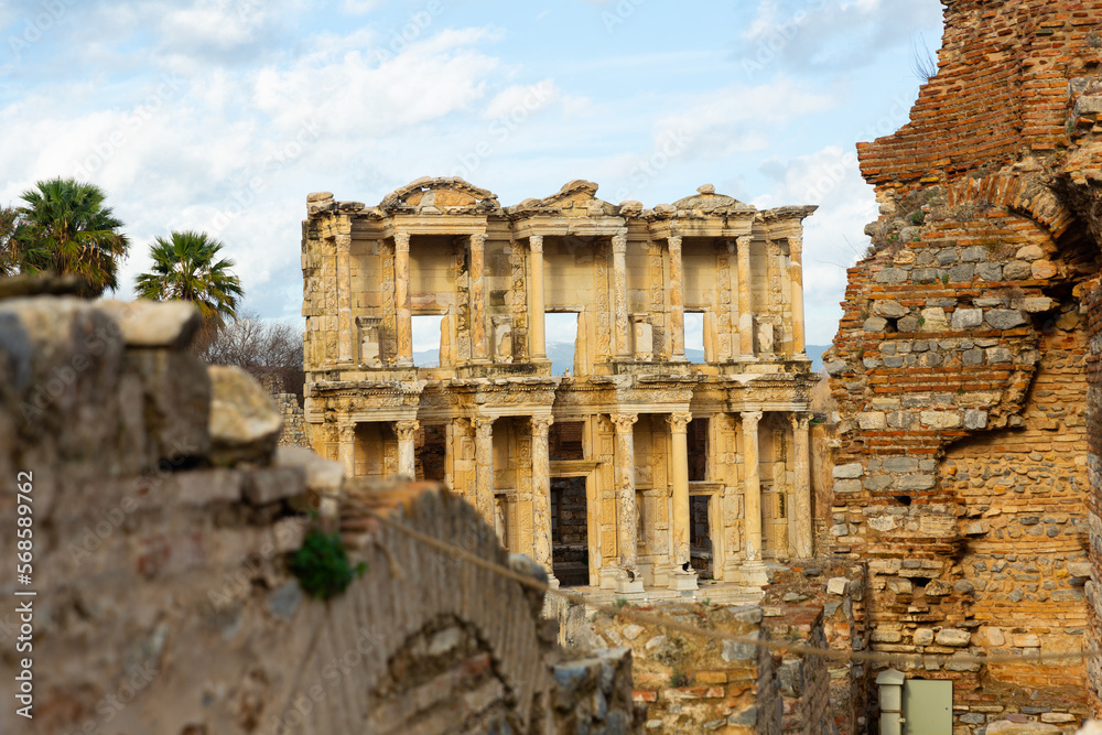 Remained reconstructed facade of Library of Celsus at ruins of ancient Greek city of Ephesus on sunny day, Turkey