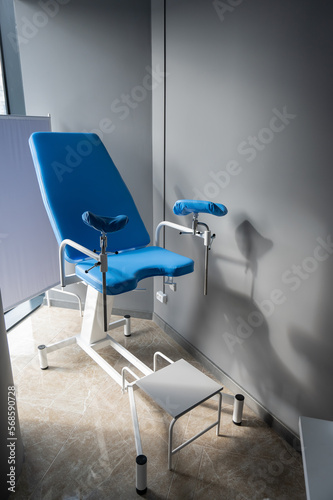 Empty blue gynecological chair in the gynecologist s office. 