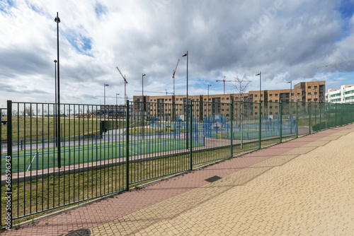 Facades of new buildings in an urbanization with common areas with sports fields