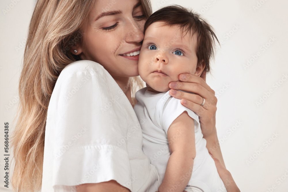 Mother hugging her cute little baby on white background, closeup Mother hugging her cute little baby on white background, closeup