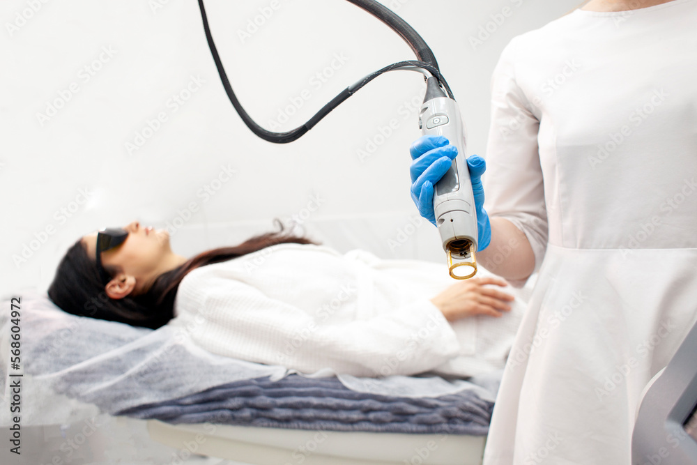 doctor cosmetologist holds an alexandrite laser in his hands in a cosmetology clinic, modern device for the epilation