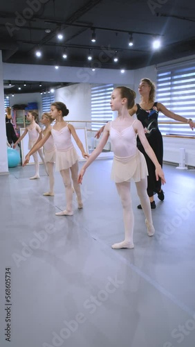 girls with teacher at ballet class, vertical video