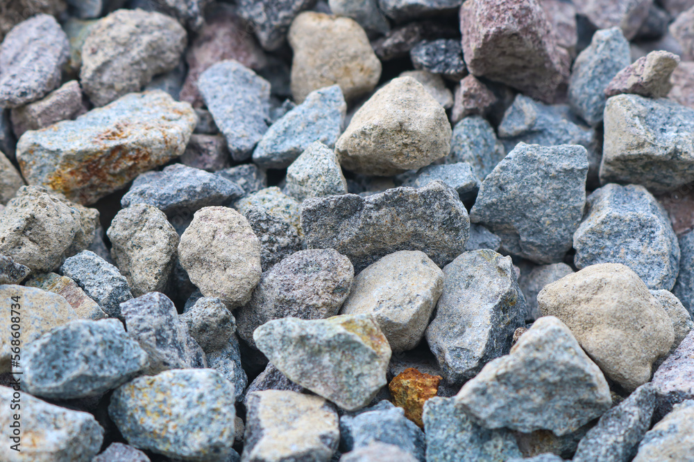 Gravel texture. Pebble stone background. Light grey closeup small rocks.