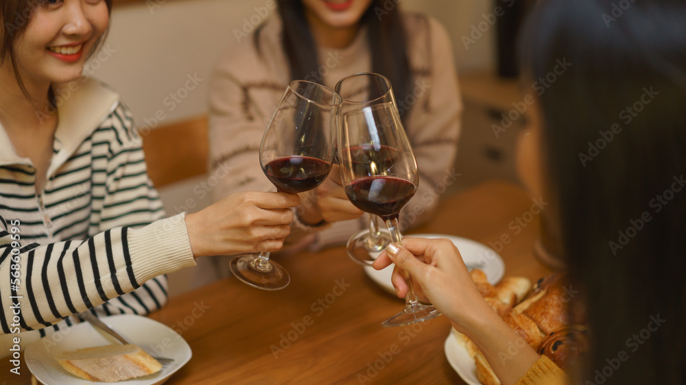 Birthday celebration concept, Asian girls clinking glass wine in dinner to celebrate birthday party