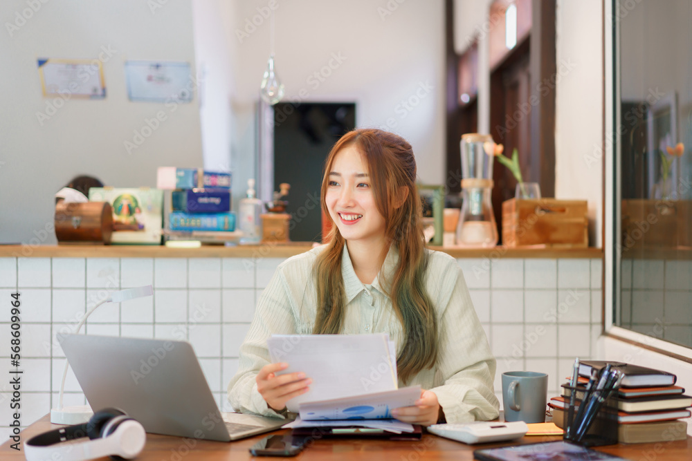 Business concept, Woman entrepreneur holding document and looking outside in coworking space office Business concept, Woman entrepreneur holding document and looking outside in coworking space office