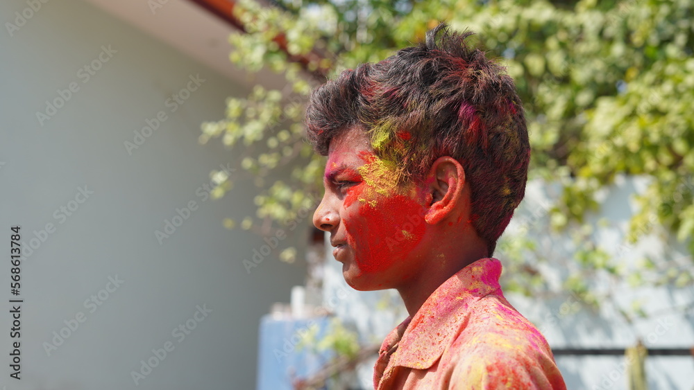 Cute indian little child playing holi. Holi is colors festival in india