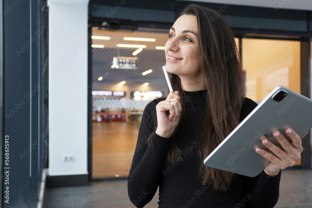 beautiful business woman in office using tablet computer texting, walking in corporate office building, checking email messages online, successful executive woman. beautiful business woman in office using tablet computer texting, walking in corporate office building, checking email messages online, successful executive woman.