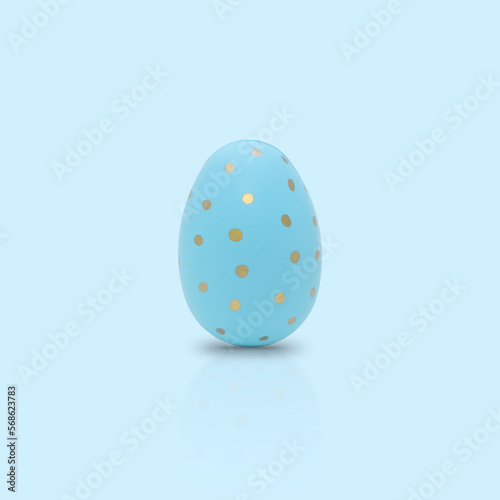 Happy Easter. Beautiful blue egg with different pattern on a blue background.