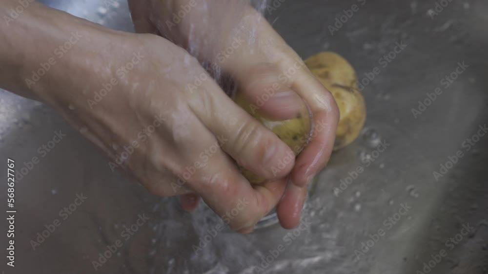 man hands wash potatoes in the sink lifestyle man hands wash potatoes in the sink lifestyle