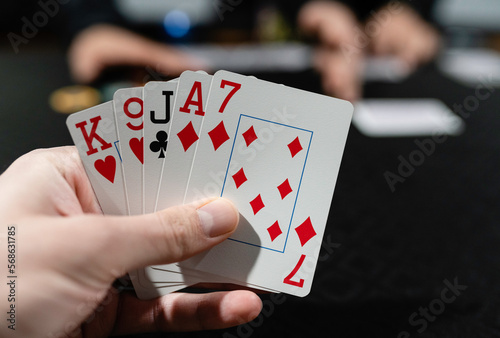 A closeup image of a poker hand of cards at a gambling table