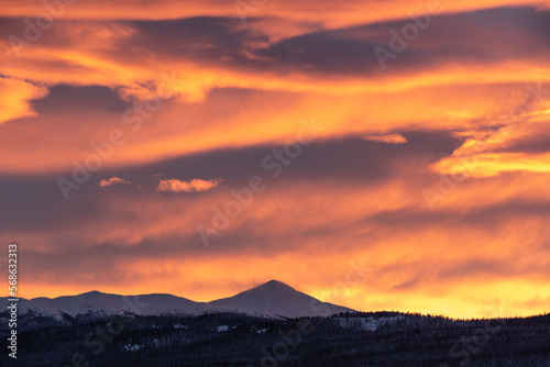 Incredible sunset views in winter season from northern Canada with bright pink clouds, mountains and snow at dusk.