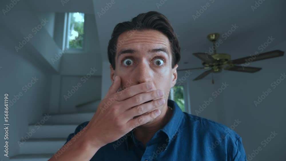 Scared man takes off his glasses and is frightened by what he sees