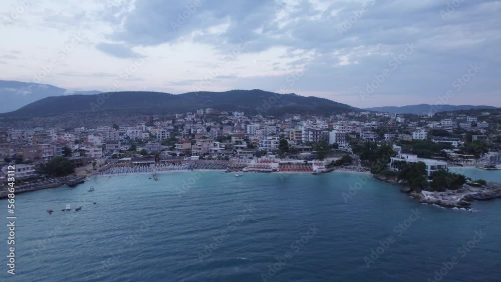 Aerial over Ksamil shore into the cityscape at dusk, Albania Aerial over Ksamil shore into the cityscape at dusk, Albania