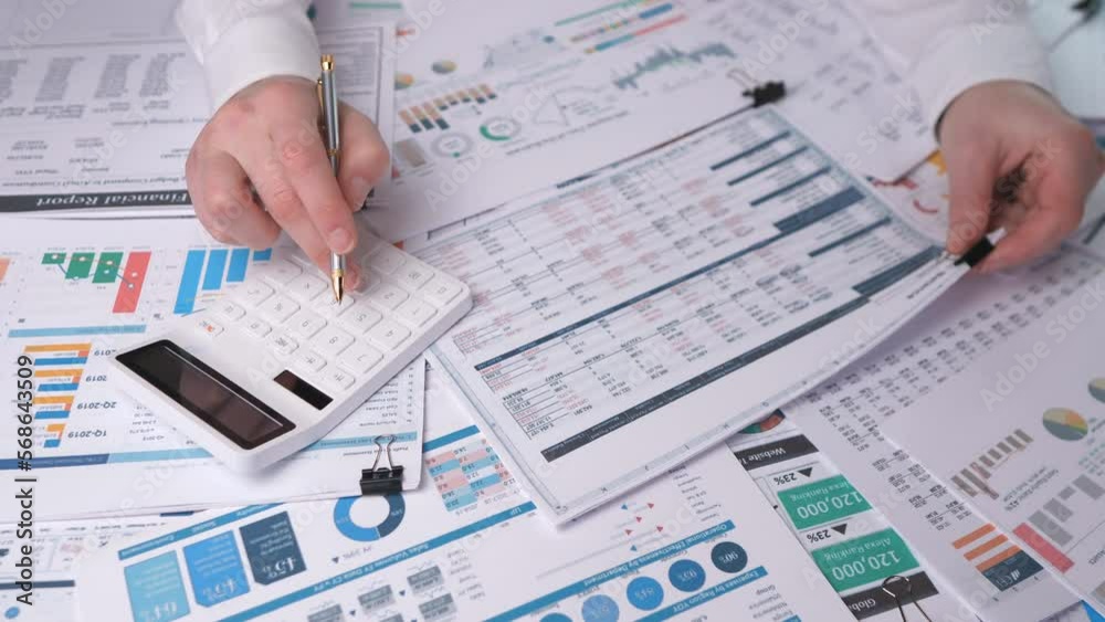 Financial report and the accountant's hands check the figures on paper, 4k slow motion Financial report and the accountant's hands check the figures on paper, 4k slow motion