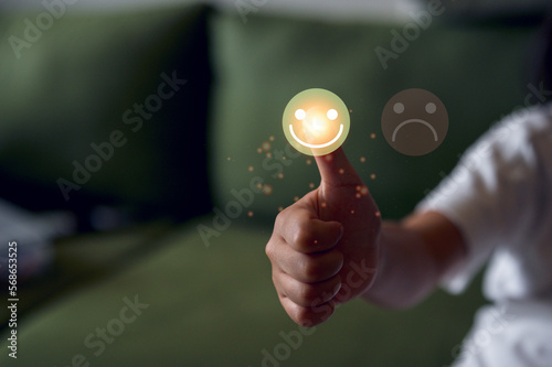 feedback Customer service satisfaction survey concept.girl show satisfaction by pressing face emoticon smile in satisfaction on virtual touch screen. happy emotion