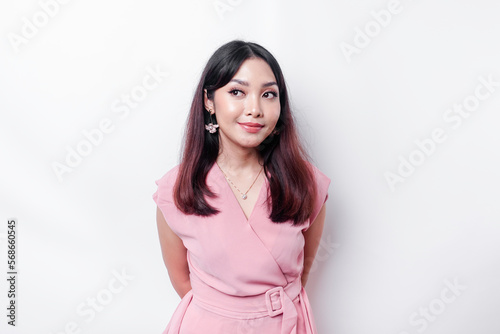 A portrait of a happy Asian woman wearing a pink blouse isolated by white background