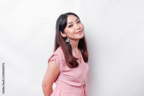 A portrait of a happy Asian woman wearing a pink blouse isolated by white background
