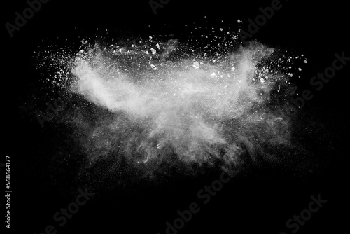 White powder explosion cloud against black background. White dust particles splash.