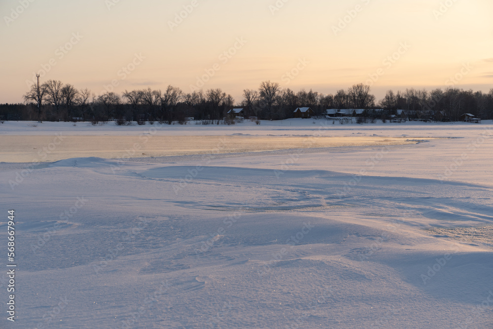 Winter sunset on the big river, hummocks in the rays of the sun. Winter sunset on the big river, hummocks in the rays of the sun.