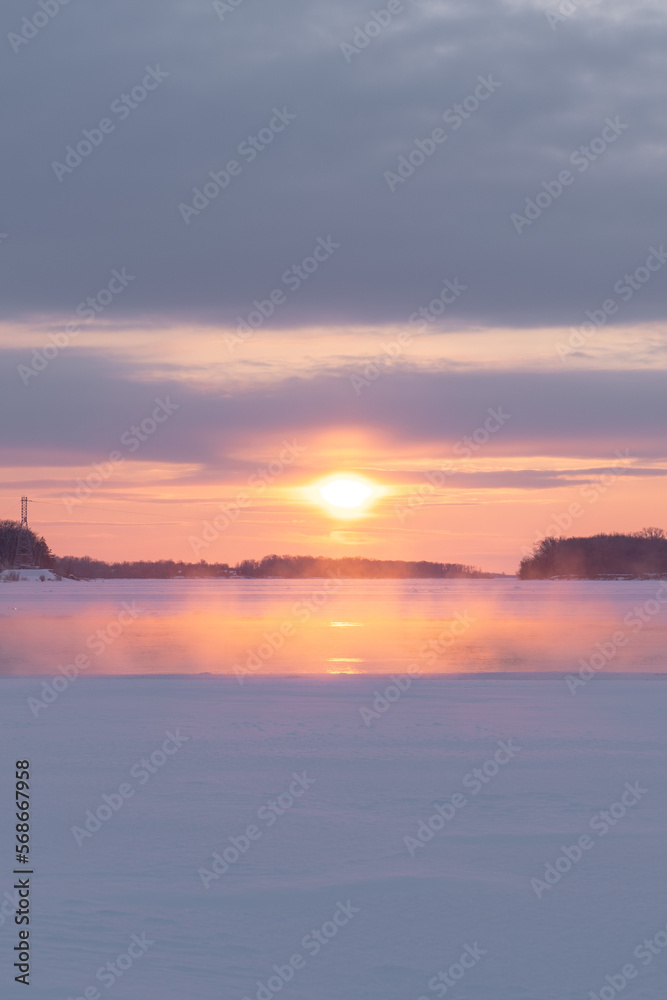 Winter sunset on the big river, hummocks in the rays of the sun. Winter sunset on the big river, hummocks in the rays of the sun.