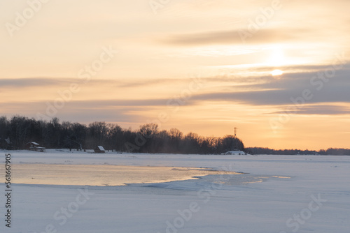 Winter sunset on the big river  hummocks in the rays of the sun.