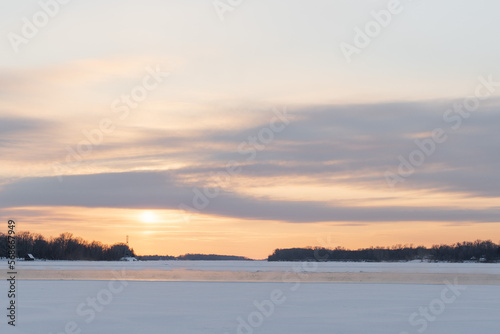 Winter sunset on the big river  hummocks in the rays of the sun.