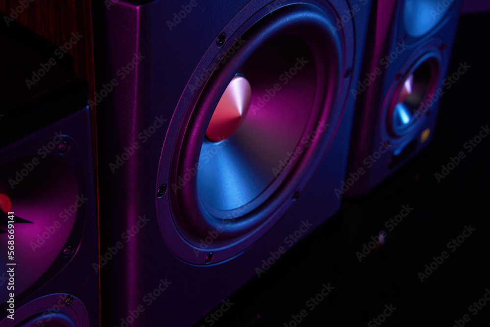 Two sound speakers and subwoofer on dark background with neon lights. Set for listening music. Acoustic equipment - obrazy, fototapety, plakaty 